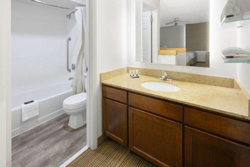 a bathroom with a sink and a toilet at Tysons Corner Suites, A Baymont by Wyndham in Vienna