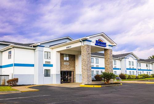 a hotel with a sign on the front of it at Baymont by Wyndham Port Wentworth in Port Wentworth