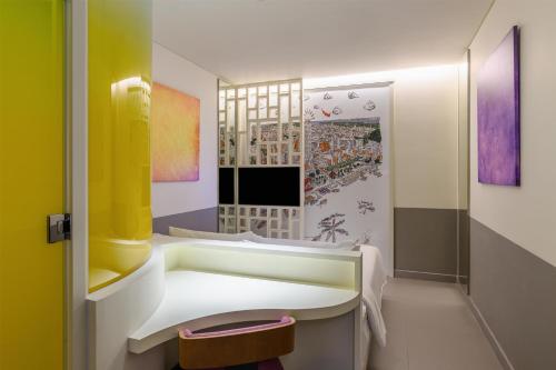 a bathroom with a sink and a mirror at Wink Danang Riverside, Unscripted by Hyatt in Da Nang