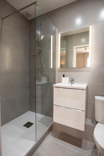 a bathroom with a shower and a sink and a toilet at Stylish & Cozy Air-Conditioned Studio in Le Pré-Saint-Gervais
