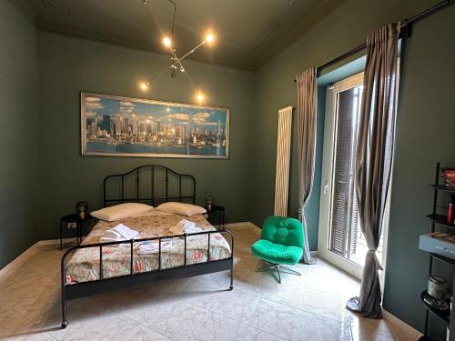 a bedroom with a bed and a chair and a window at Bari Holiday Garibaldi 74 in Bari