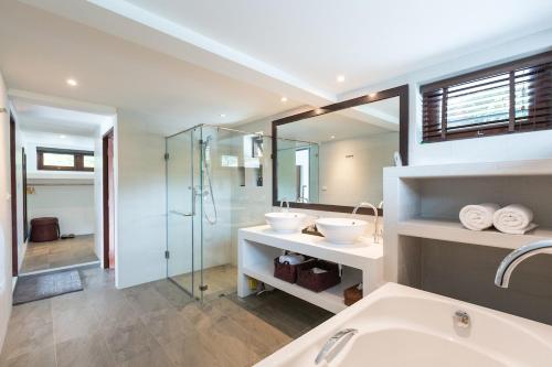 a bathroom with a sink and a glass shower at The Secret Beach Villa in Mae Haad