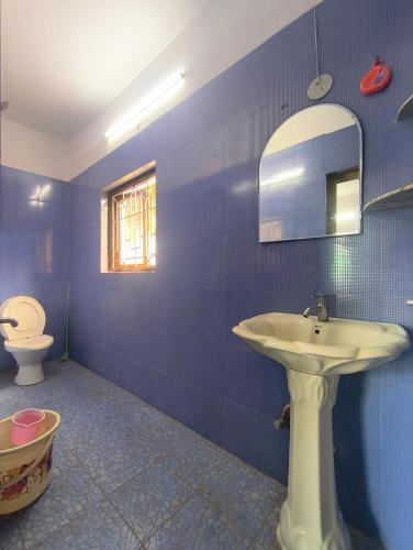 a bathroom with a sink and a toilet at Morni Home's morjim in Morjim