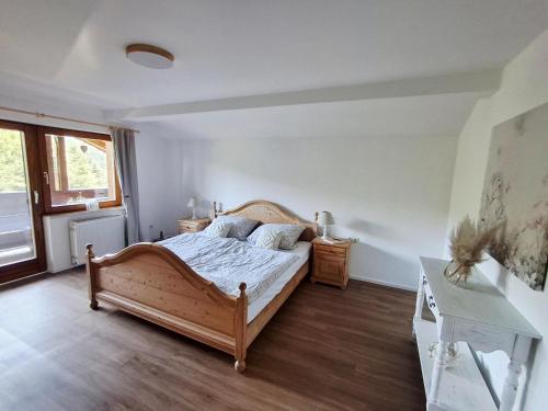 a bedroom with a wooden bed in a room at Ferienwohnung Goldfasan in Lam