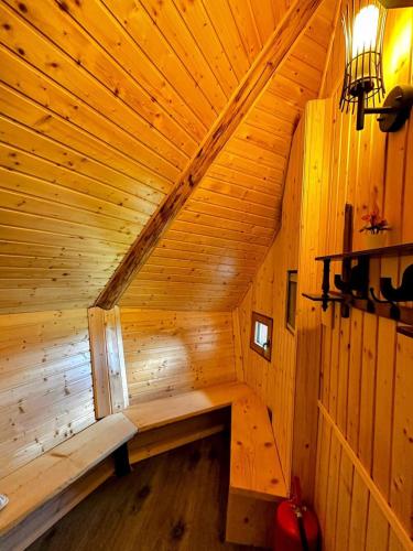 a wooden room with a bench in a wooden cabin at Koča Velika Planina - Chalet Kamrica in Stahovica