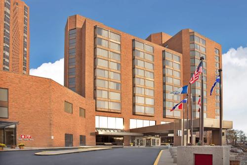 a building with american flags in front of it at Wyndham Gatineau-Ottawa & Conference Centre in Gatineau