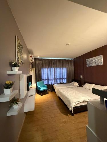 a bedroom with a large bed and a window at Mikayla Suite in Kota Bharu