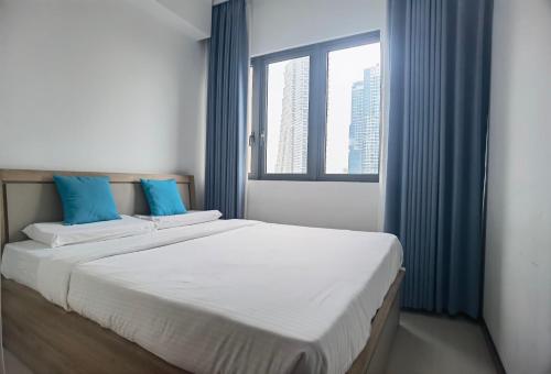 a bedroom with two beds and a large window at Colombo Trizen J&J future Apart ment in Colombo