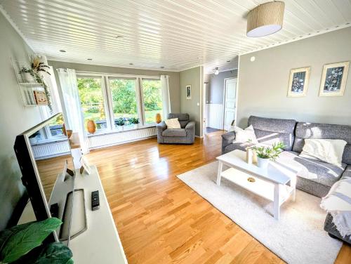 a living room with a couch and a table at Host Harmony 6 PP Cabin Close to lake in Vittsjö