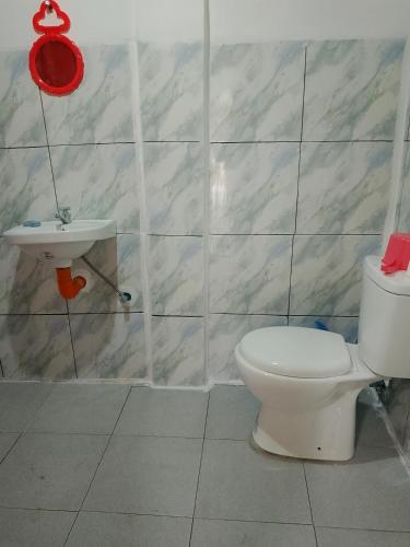 a bathroom with a toilet and a sink at Nory's Tourist Inn in San Vicente
