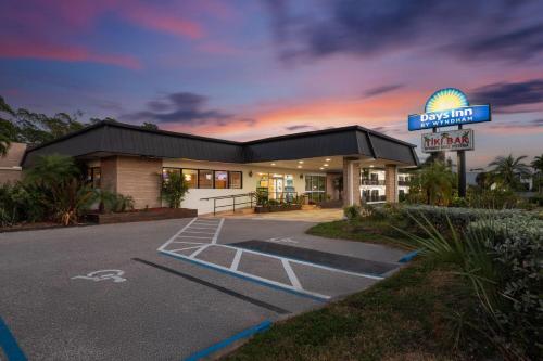 a building with a sign in front of a motel at Days Inn by Wyndham Fort Myers Springs Resort in Estero