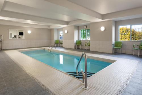 a large swimming pool in a hotel room at Microtel Inn & Suites Sault Ste. Marie in Sault Ste. Marie