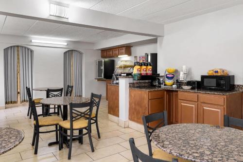 a kitchen and dining room with tables and chairs at Days Inn by Wyndham Hagerstown I-70 in Hagerstown