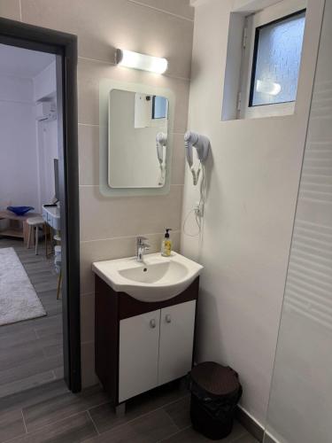 a bathroom with a sink and a mirror at Parlament Residence in Bucharest
