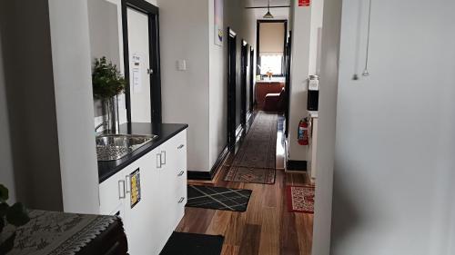 a hallway of a room with a sink and a counter at The Eastern Hotel Accommodation in Ballarat