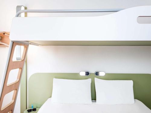 a bunk bed with two pillows in a room at ibis budget Brugge Centrum Station in Bruges