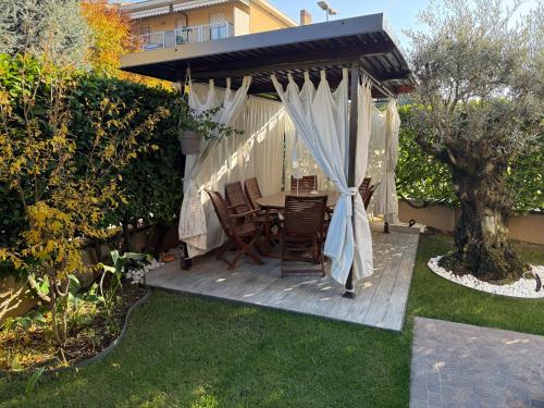 a patio with a table and chairs under a canopy at Villa Fenix Seriate in Seriate