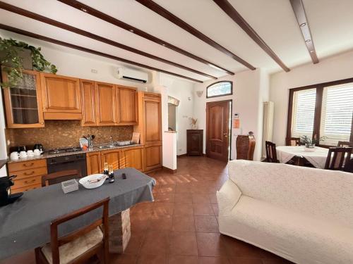 a kitchen and living room with a couch and a table at Villa Fenix Seriate in Seriate