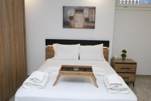 a bedroom with a bed with a table on it at Emily Apartments 3 in Chrysoupolis