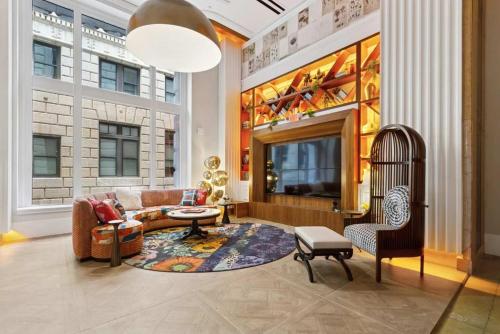 a living room with a couch and a bird cage at CozySuites at Sky Central in Cincinnati