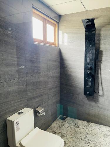 a bathroom with a toilet and a walk in shower at Can win Resort Yala in Tissamaharama