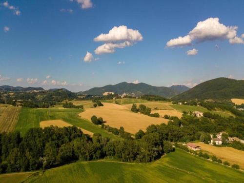 an aerial view of green fields and mountains at Apartment in a farmhouse with 2 swimming pools in Cagli