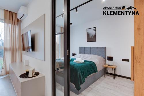 a bedroom with a bed and a sliding glass door at Klementyna in Bystra