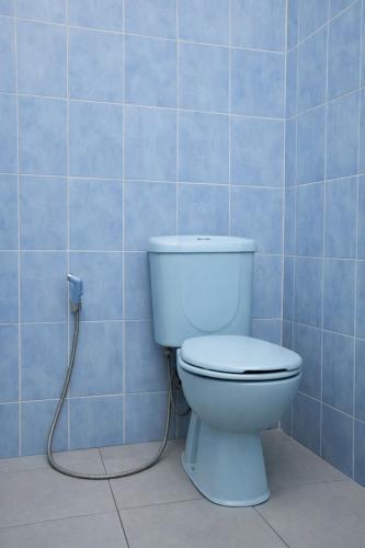 a bathroom with a toilet with a hose at Hotel Danau Indah By ARBA in Cibuntu