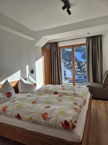 a bedroom with a large bed and a window at Reiterhof in Westendorf