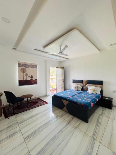 a bedroom with a bed and a table in it at Hill Touch Villa in Thūr