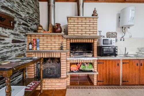 a kitchen with a brick oven in a kitchen at Casa da Passagem in Vila Real
