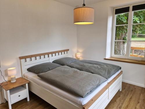 a bedroom with a large bed and a window at Ferien im Denkmal in Sundern