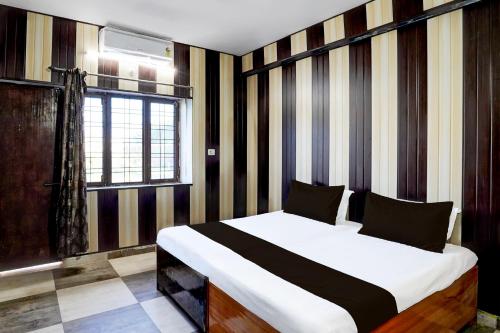 a bedroom with a large bed in a room at Hotel O Govind Guest house in Jhājra