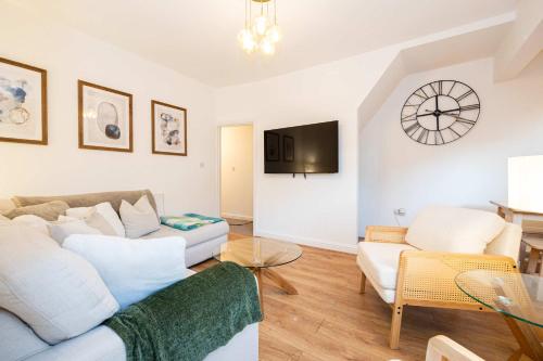 a living room with a couch and a table at Goulder House- Close To Motorway & CO-OP Live in Manchester