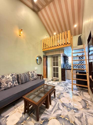 a living room with a couch and a table at Magic holiday home in Matheran