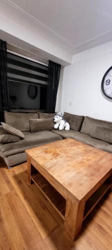 a teddy bear sitting on a couch with a coffee table at townhouse at the city in Enschede