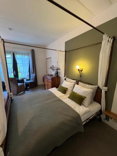 En eller flere senge i et værelse på Heerlijk Gaanderhei