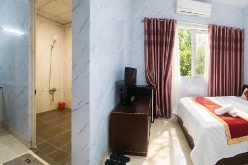 a bedroom with a bed and a bathroom with a shower at Duy Khang 1 Hotel in Ho Chi Minh City