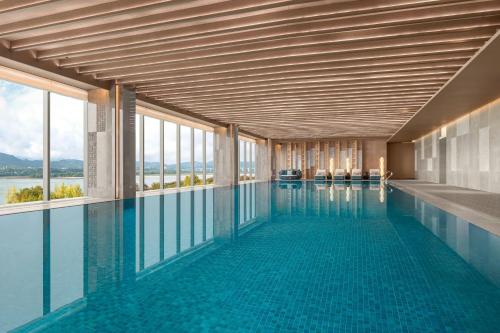 a swimming pool with a view of the water at The Westin Yichang in Yichang