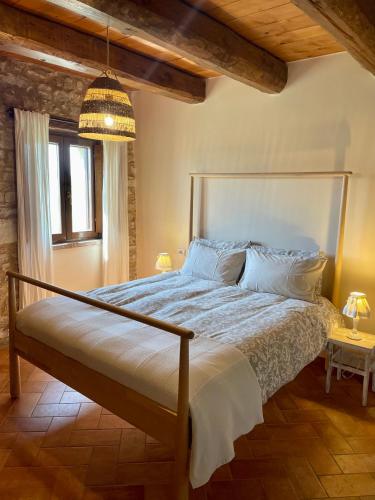 a bedroom with a large bed in a room at Casale le Fontanelle in Monte Grimano Terme