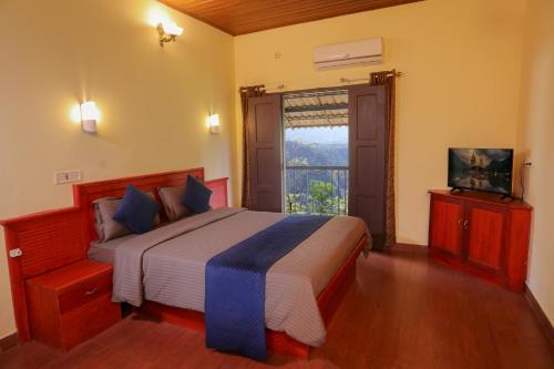 a bedroom with a large bed and a window at Rippon Mount Resorts in Meppādi
