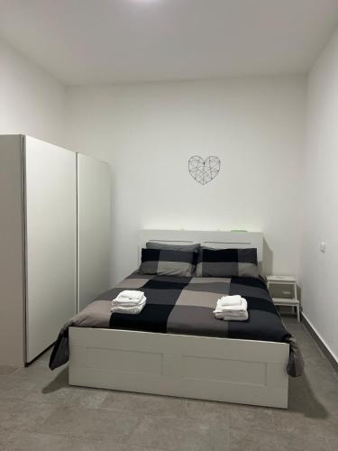 a bedroom with a large bed in a white room at SantegidioHomeCesena in Cesena