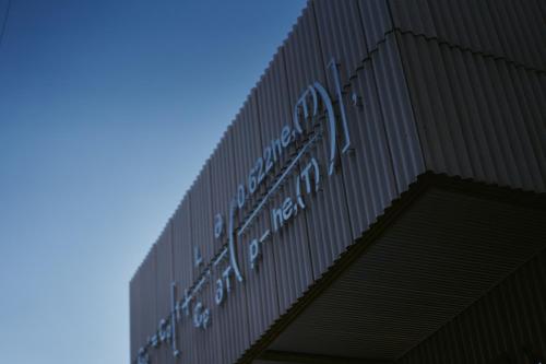 a sign on the side of a building at A&A Okayama in Okayama