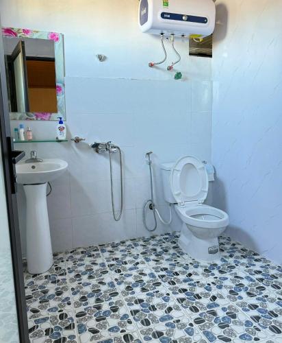 a bathroom with a shower and a toilet and a sink at Hostel 405 Sa Pa in Sapa