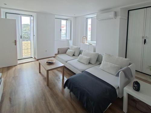 En eller flere senge i et værelse på Casa do Coronel de Alcochete