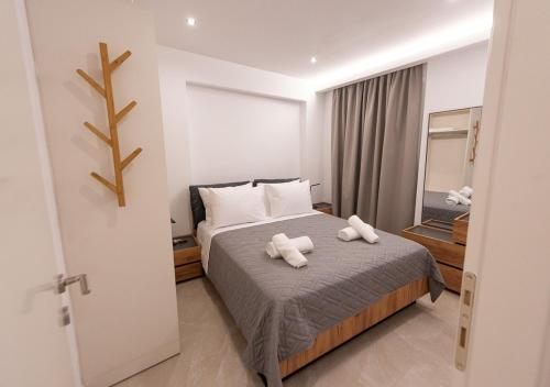 a bedroom with a bed with two towels on it at Sinani Villas Rhodes in Afantou