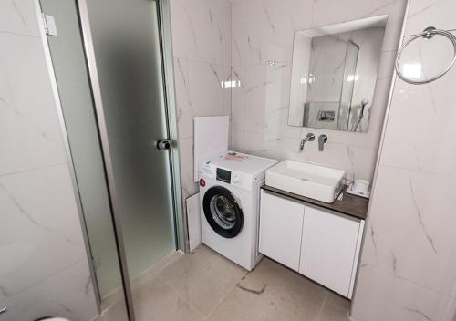a bathroom with a washing machine and a sink at Sinani Villas Rhodes in Afantou