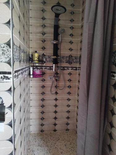 a shower in a room with a shower curtain at Luxurious mountain villa avec wifi in El Ksiba