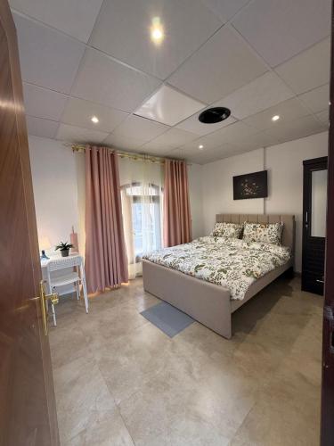 a bedroom with a bed and a desk in it at Grand Stay Abu Dhabi in Abu Dhabi