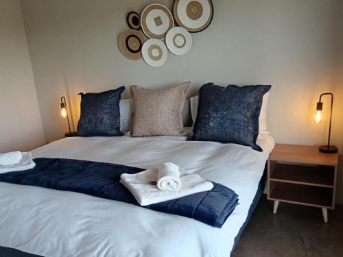 a bedroom with a large bed with towels on it at Leopolds Rest in Prieska